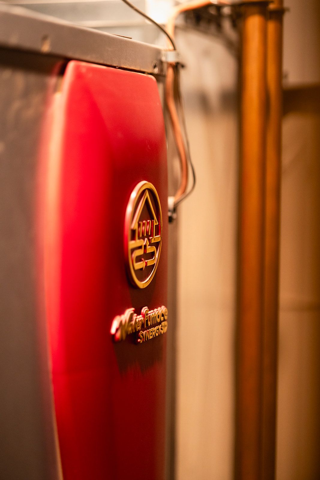 Red wall-hung boiler installed in a mechanical room